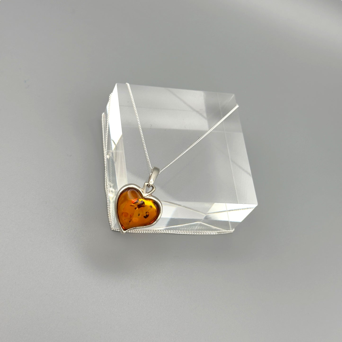 Sterling silver necklace with heart amber pendant