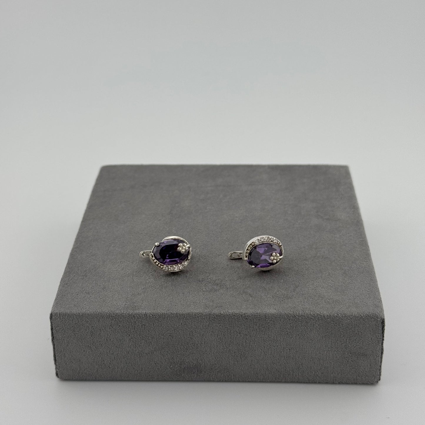sterling silver amethyst earrings with an oval amethyst stone and floral design