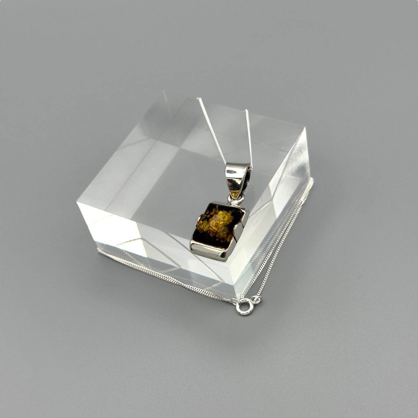 Sterling silver chain with amber pendant in box setting
