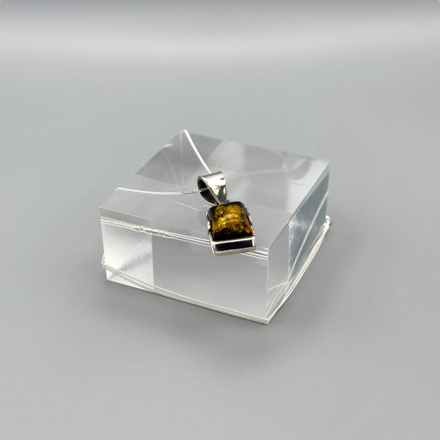 Baltic amber silver pendant with chain draped
