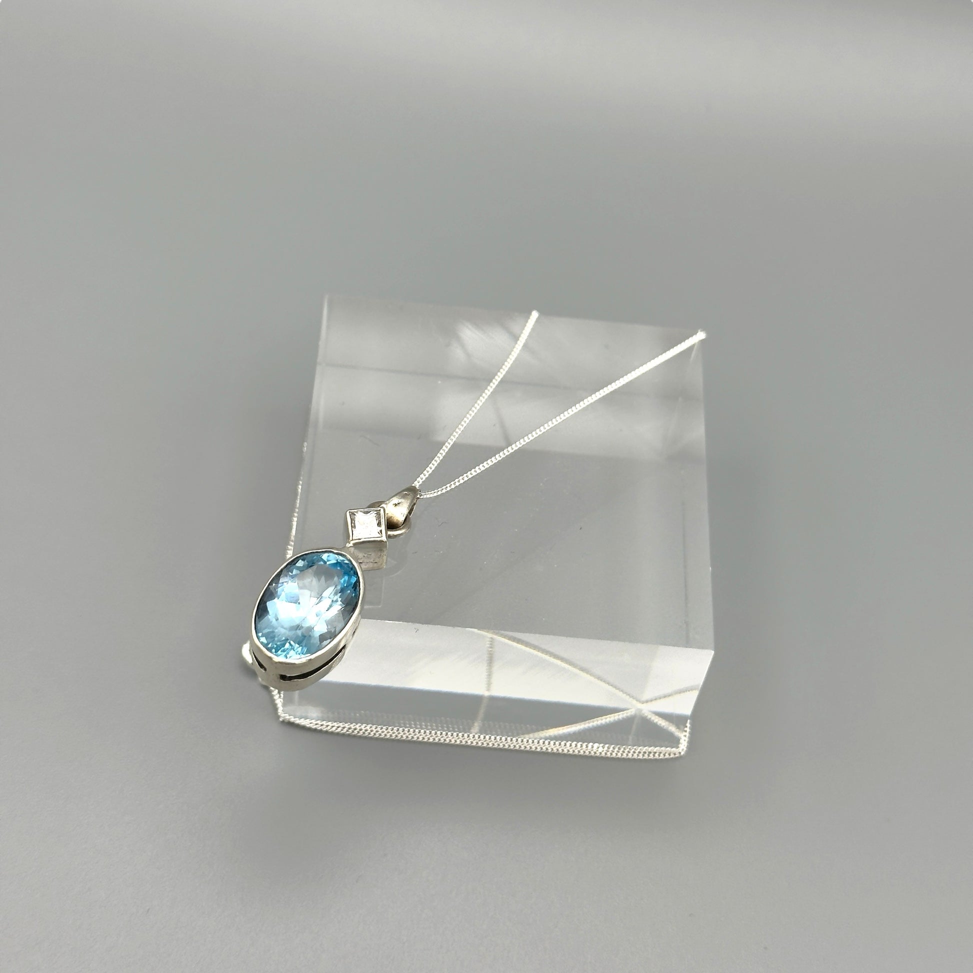 Aquamarine and silver pendant necklace photographed flat