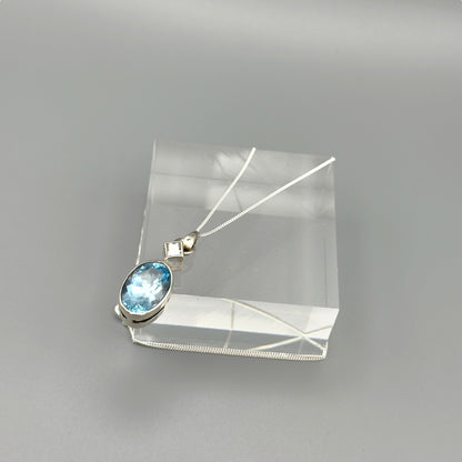 Aquamarine and silver pendant necklace photographed flat