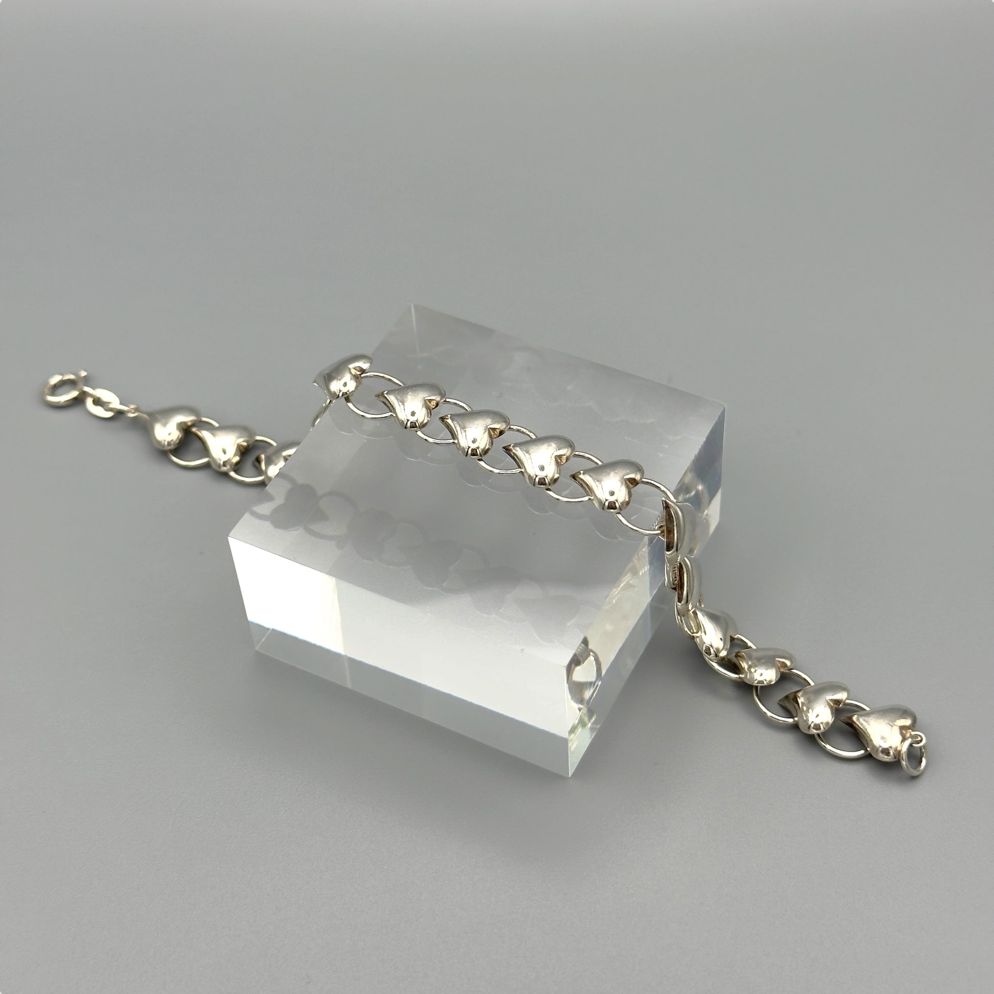 Flat lay of silver heart link bracelet