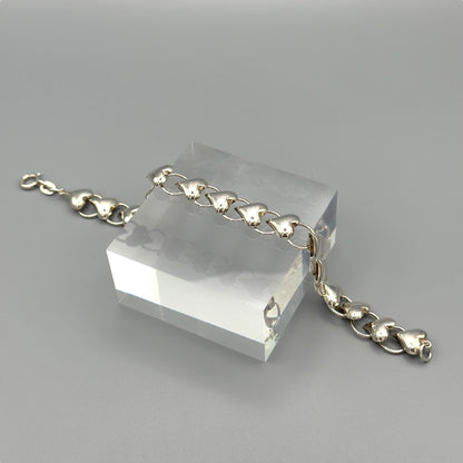 Flat lay of silver heart link bracelet