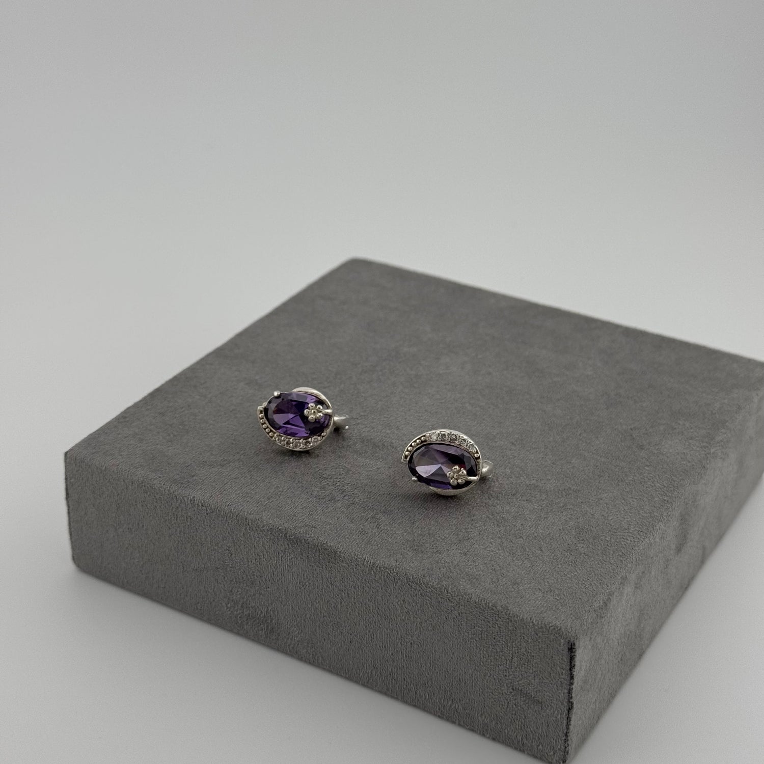 sterling silver amethyst earrings with an oval amethyst stone and floral design