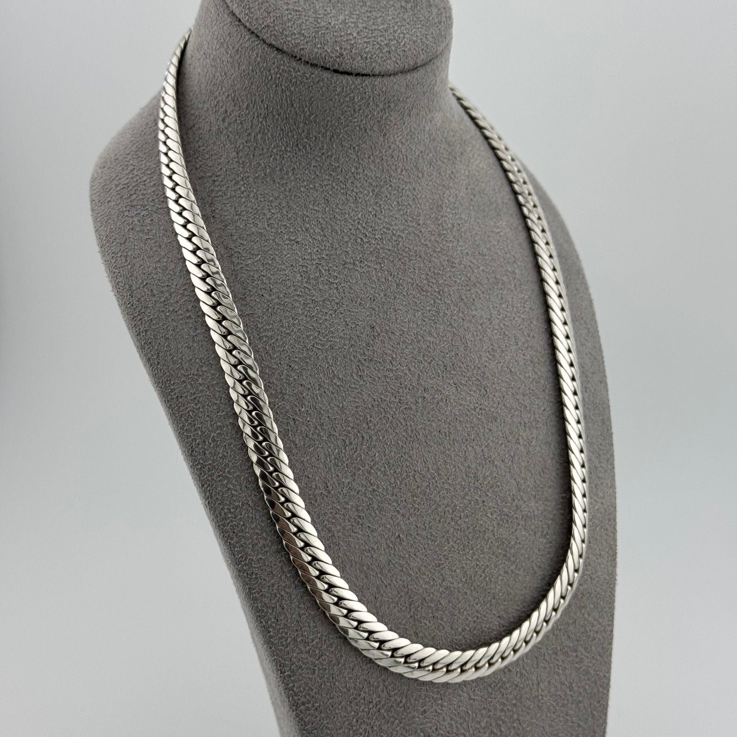 sterling silver heavy  herringbone chain 20 Inches in length on a grey bust