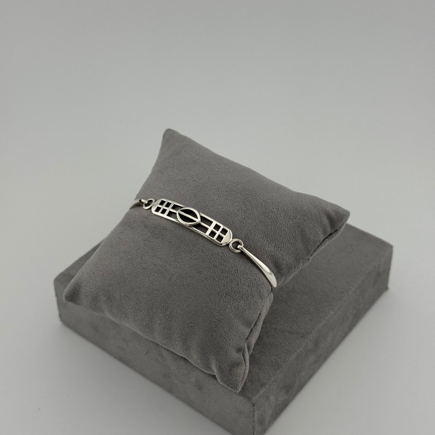 silver kit heath bracelet displayed on grey cushion 