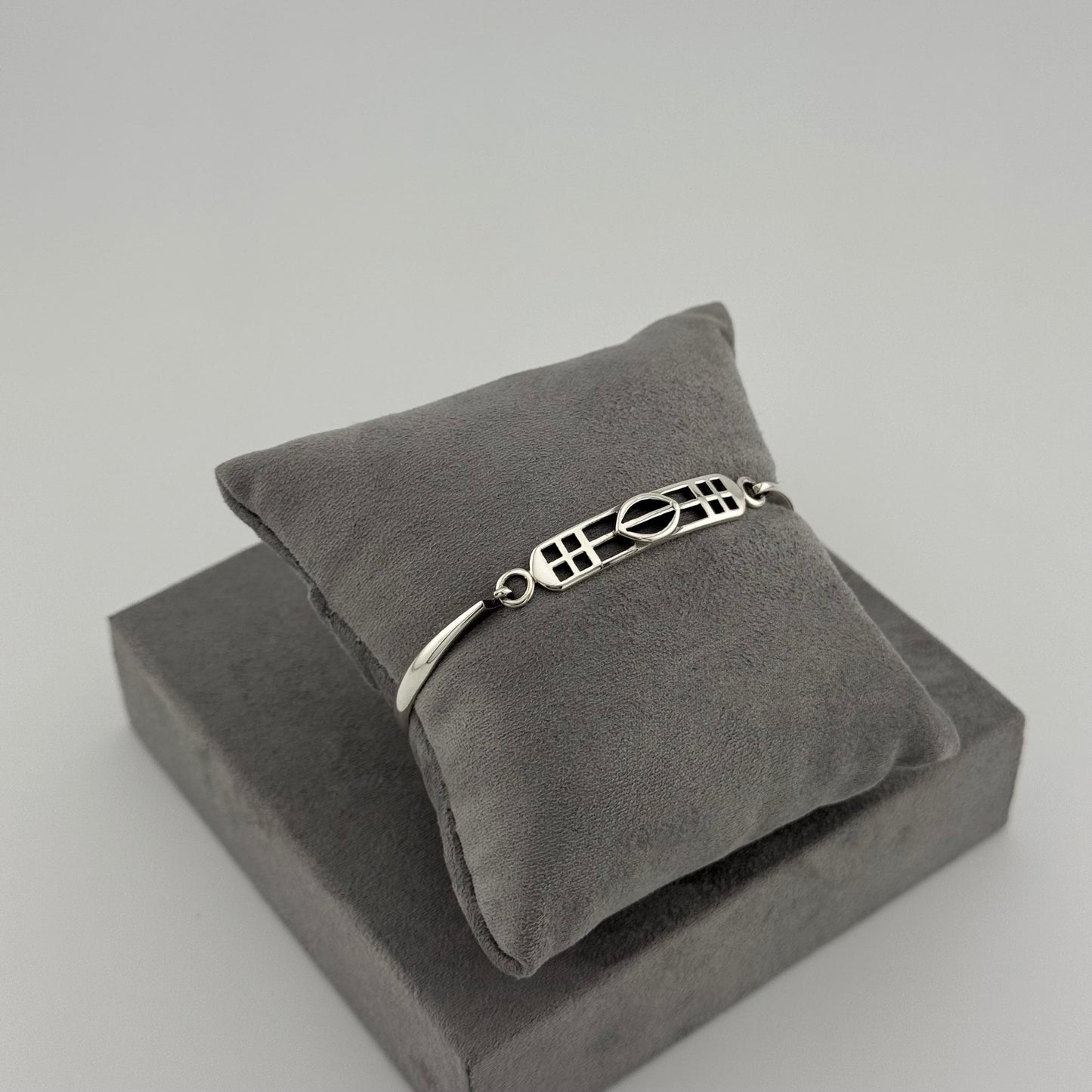 silver kit heath bracelet displayed on grey cushion 
