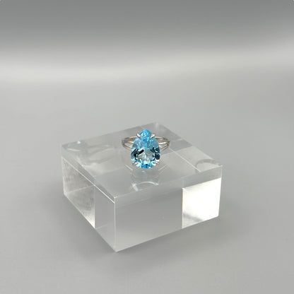 Sterling silver ring with pear-cut aquamarine on acrylic block