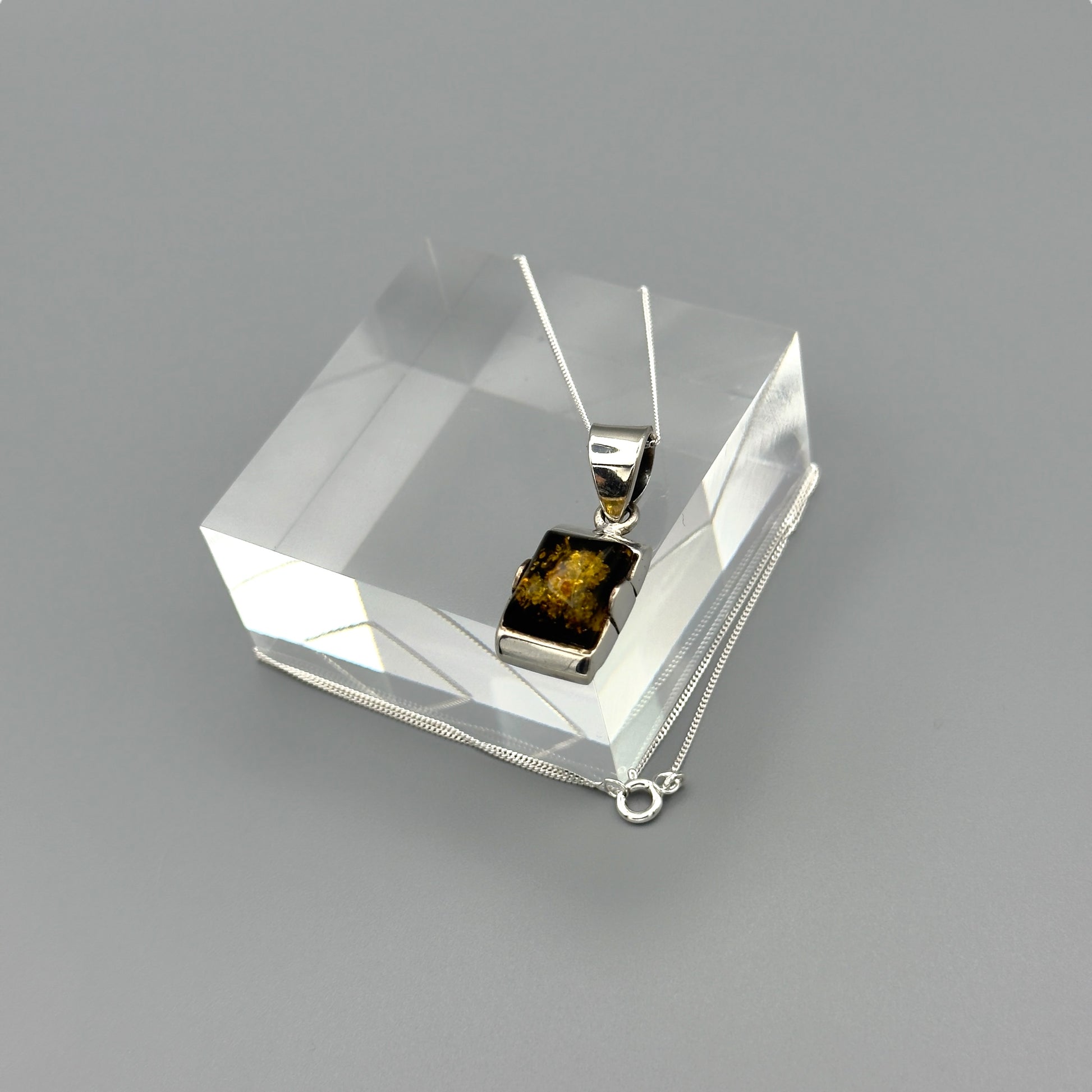 Sterling silver chain with amber pendant in box setting