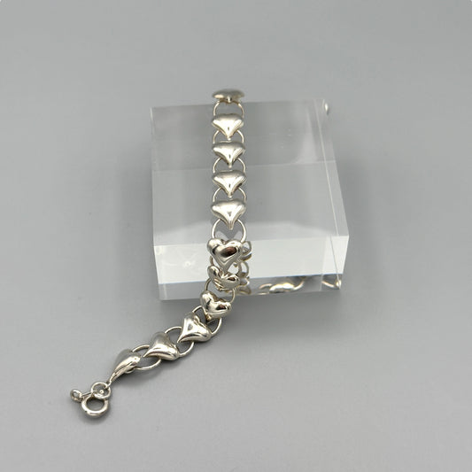 Sterling silver heart bracelet on acrylic display