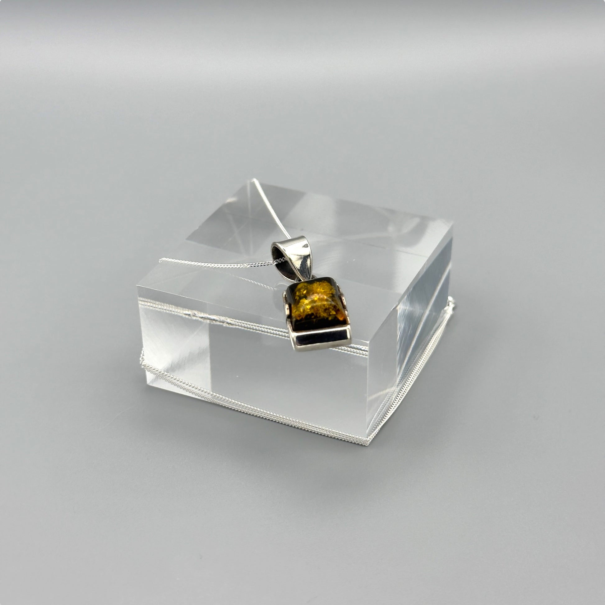 Baltic amber silver pendant with chain draped