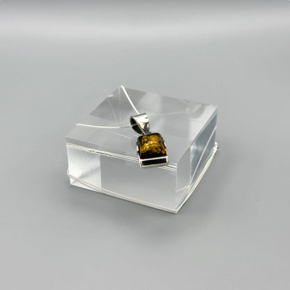 Baltic amber silver pendant with chain draped