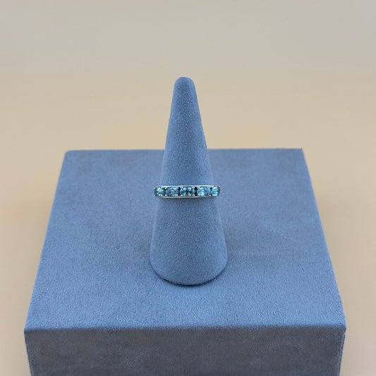Aquamarine Ring on a blue cone-shaped stand with a beige background
