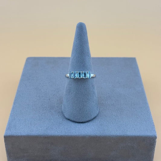 Aquamarine Ring on a blue cone-shaped stand with a beige background