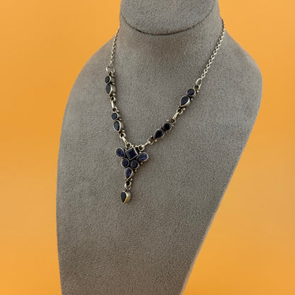 Necklace with a pendant on a gray mannequin bust against an orange background