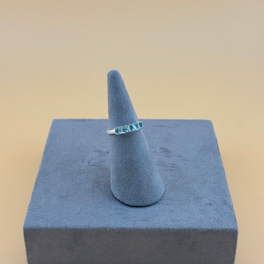 Aquamarine Ring on a blue cone-shaped stand against a beige background