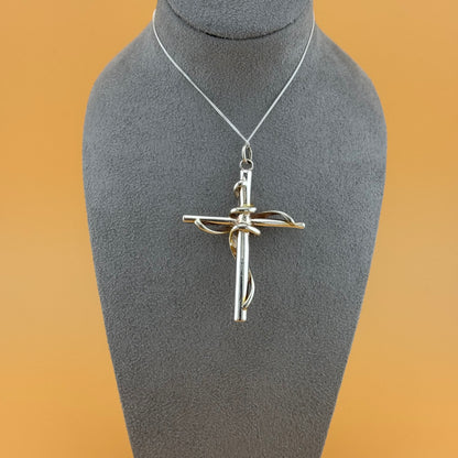 Silver cross pendant on a mannequin bust